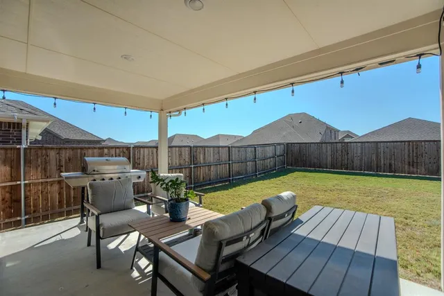 a view of a chairs and table in the patio