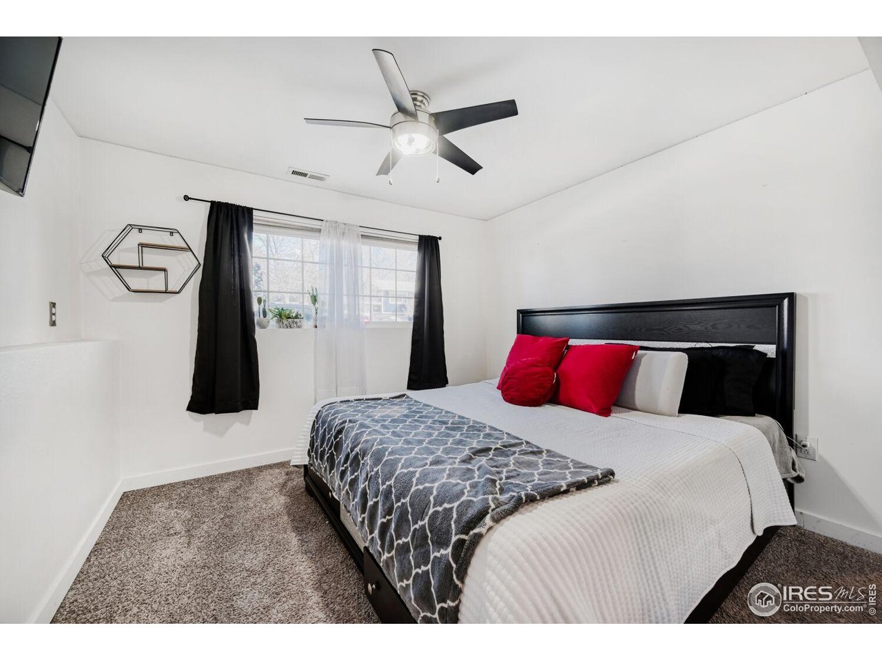 223 Fifth Street Firestone, CO 80520 - Photo 11 of 27 a bedroom with a bed and a ceiling fan