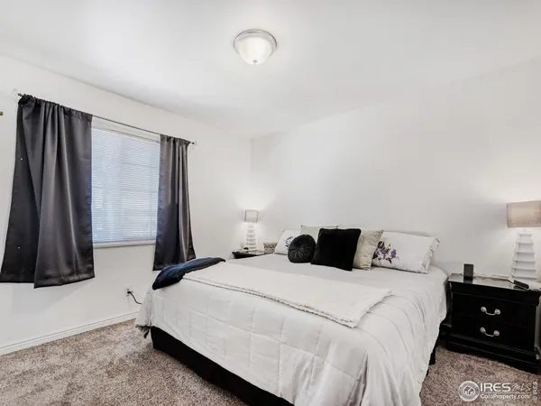 a bedroom with a bed and a night stand