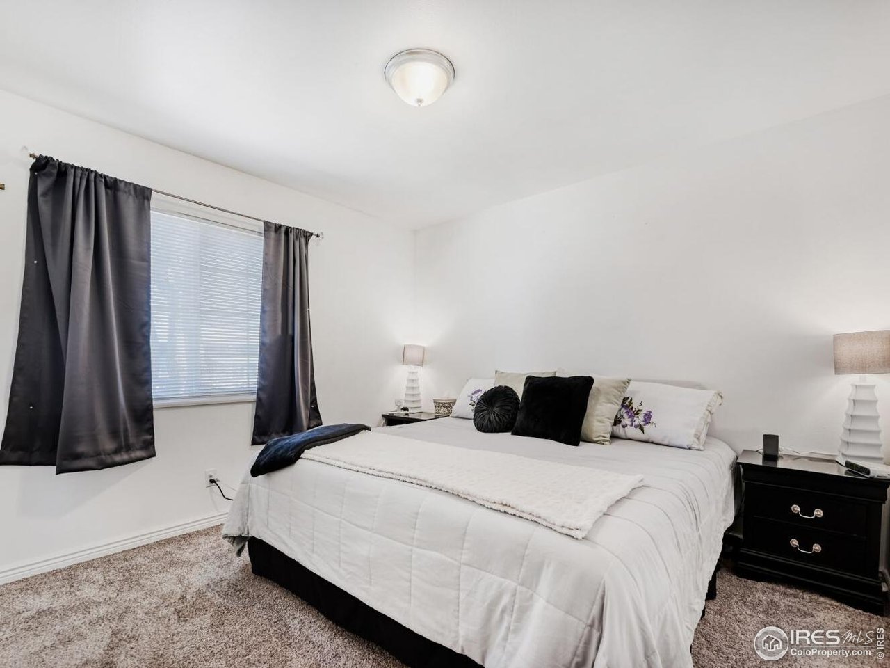 223 Fifth Street Firestone, CO 80520 - Photo 13 of 27 a bedroom with a bed and a night stand