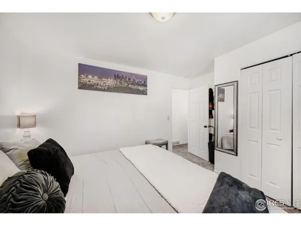 a bedroom with a bed and a painting on the wall