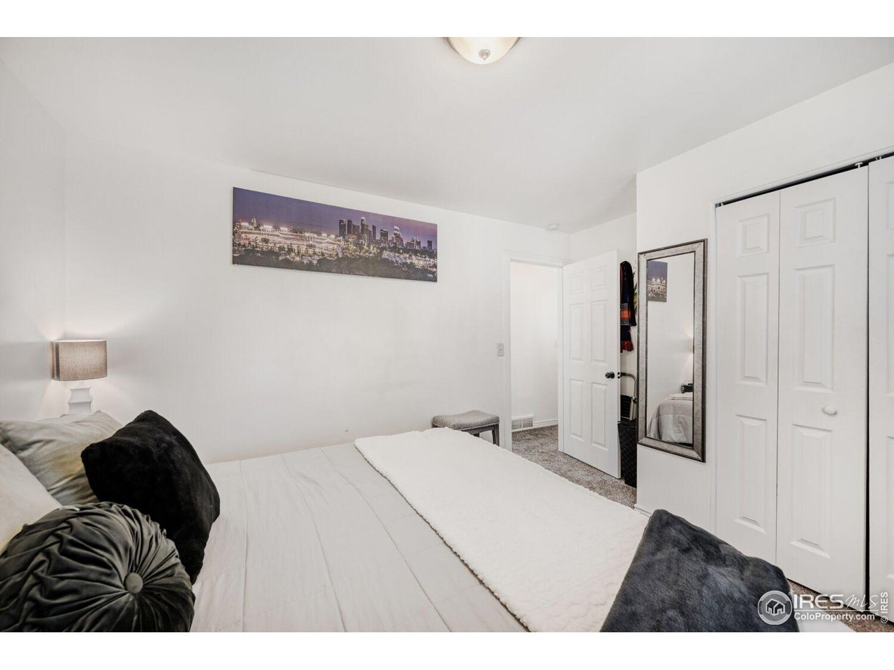 223 Fifth Street Firestone, CO 80520 - Photo 14 of 27 a bedroom with a bed and a painting on the wall
