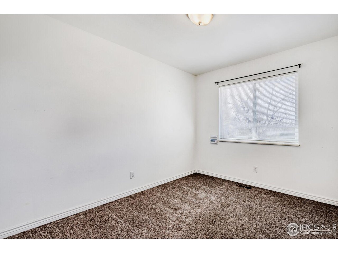 223 Fifth Street Firestone, CO 80520 - Photo 19 of 27 an empty room with a window