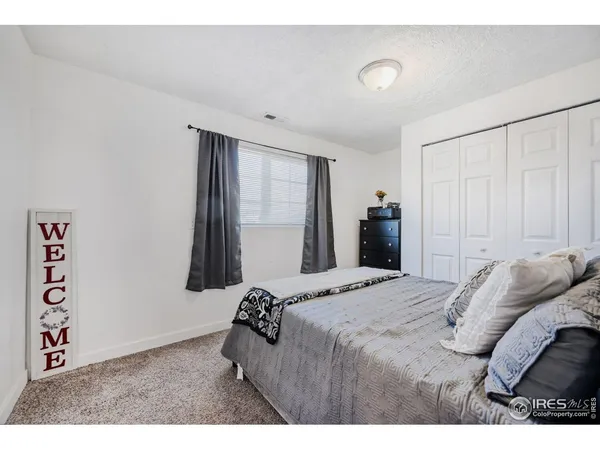 a bedroom with a bed and a walk in closet with window