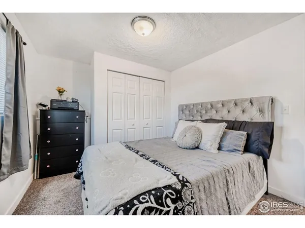 a bedroom with a bed and a closet