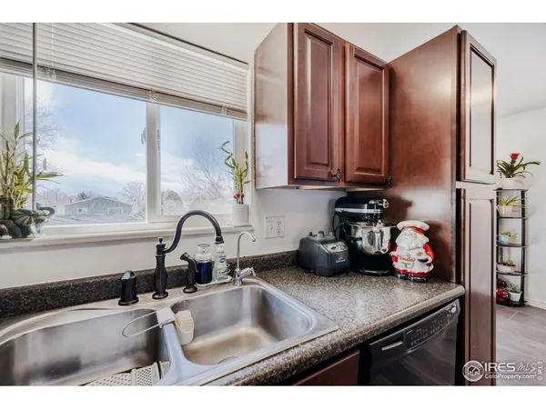 a kitchen with granite countertop a sink and potted plant