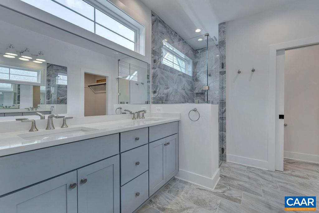 3 B Rothwell Lane, Unit LOT 3B Crozet, VA 22932 - Photo 15 of 29 a spacious bathroom with a double vanity sink and mirror