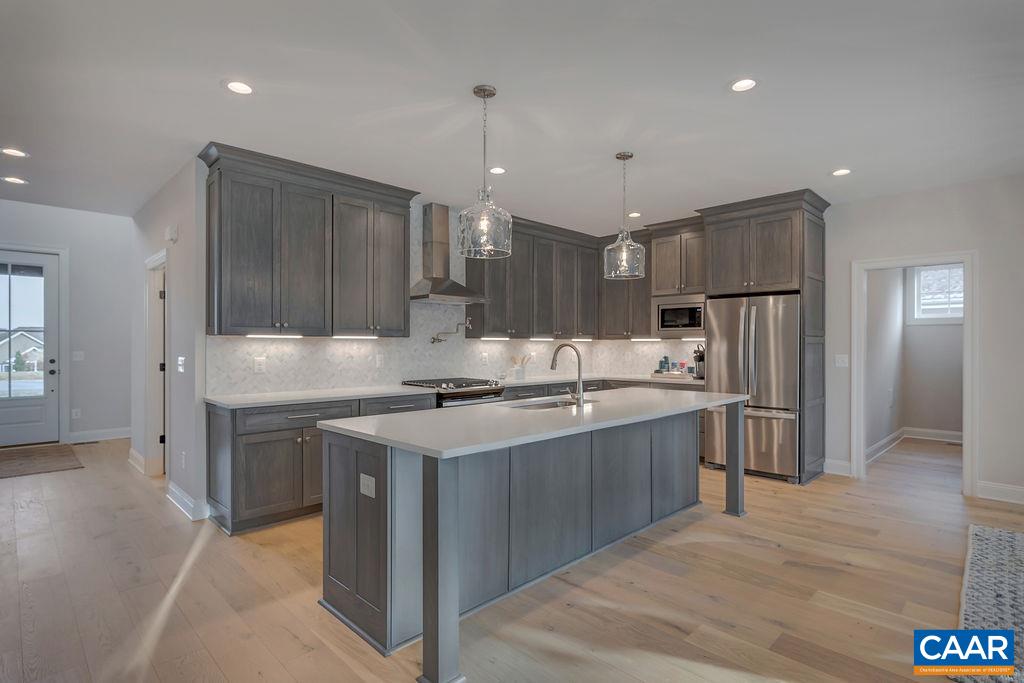 3 B Rothwell Lane, Unit LOT 3B Crozet, VA 22932 - Photo 3 of 29 a kitchen with kitchen island a sink stainless steel appliances and cabinets
