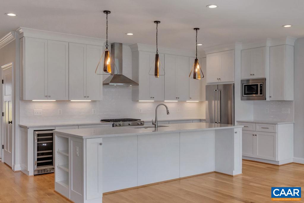 3 B Rothwell Lane, Unit LOT 3B Crozet, VA 22932 - Photo 4 of 29 a kitchen with stainless steel appliances granite countertop a sink a stove a refrigerator and island with wooden floor