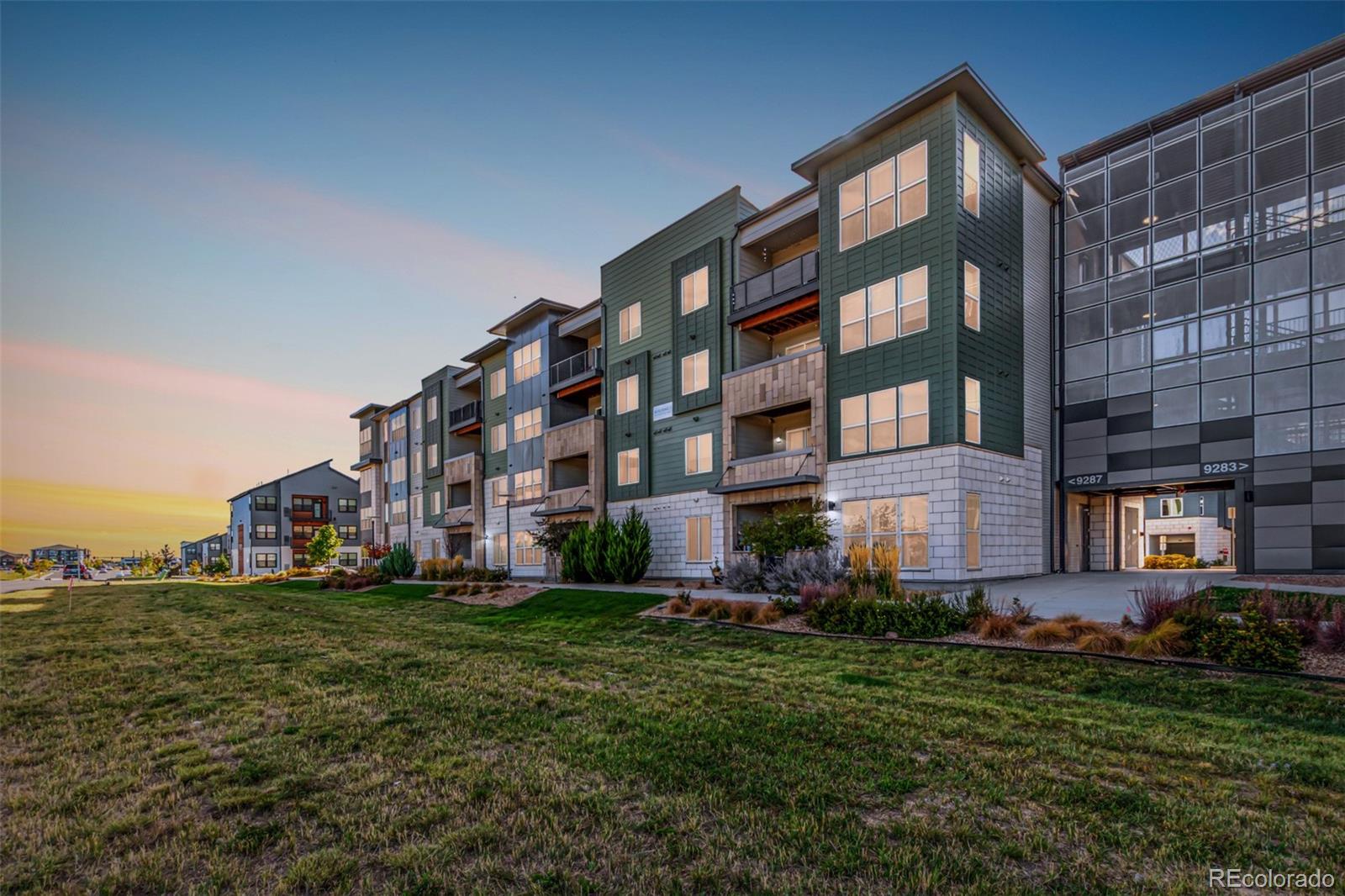 9287 Twenty Mile Road, Unit 204 Parker, CO 80134 - Photo 1 of 30 a large building with a yard