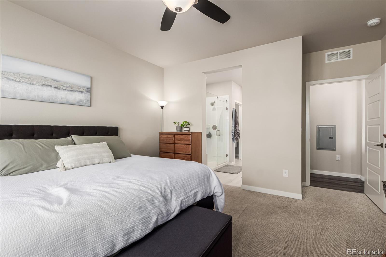 9287 Twenty Mile Road, Unit 204 Parker, CO 80134 - Photo 13 of 30 a spacious bedroom with a bed and a walk in closet