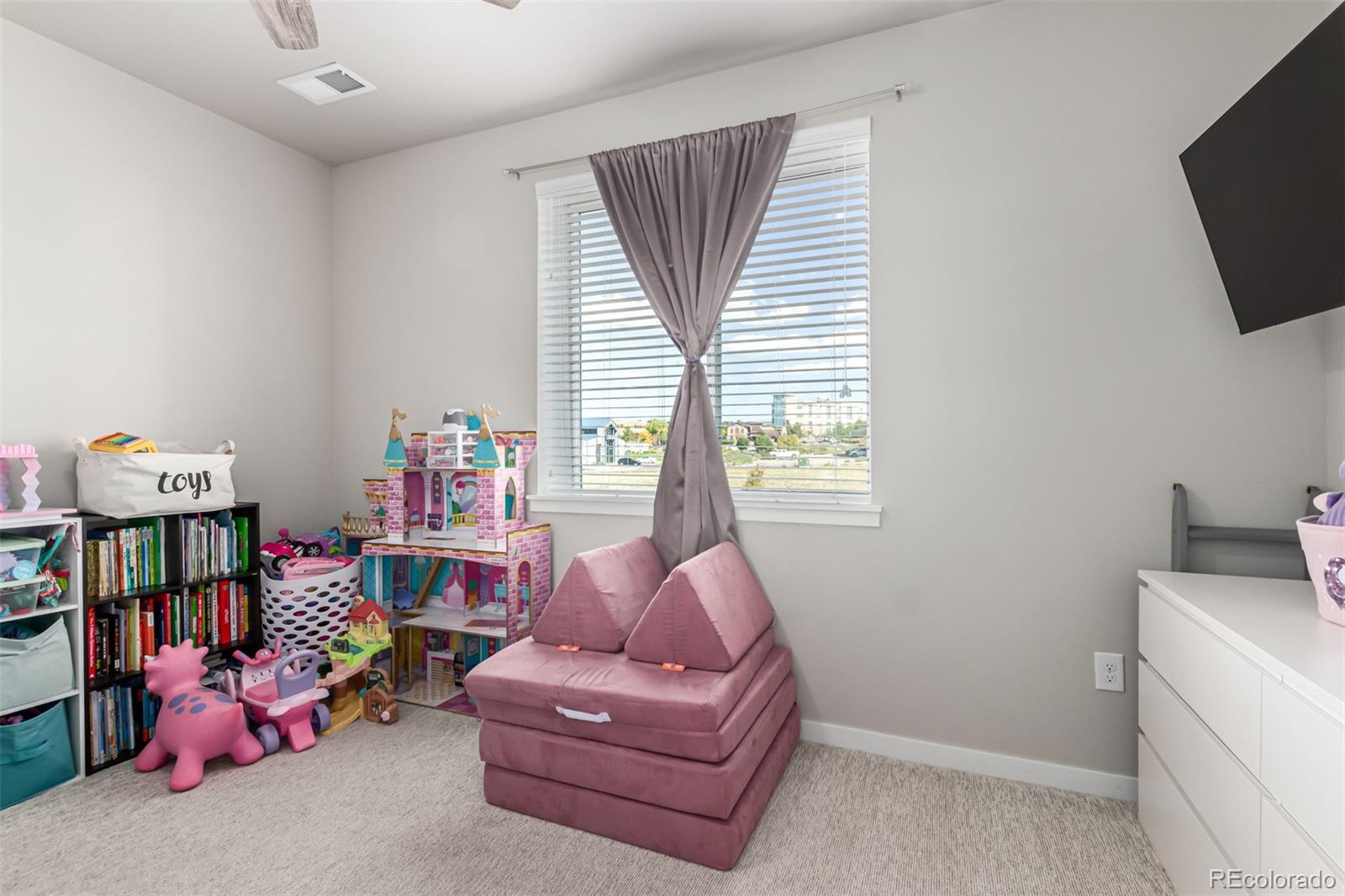 9287 Twenty Mile Road, Unit 204 Parker, CO 80134 - Photo 17 of 30 a living room with furniture and a flat screen tv