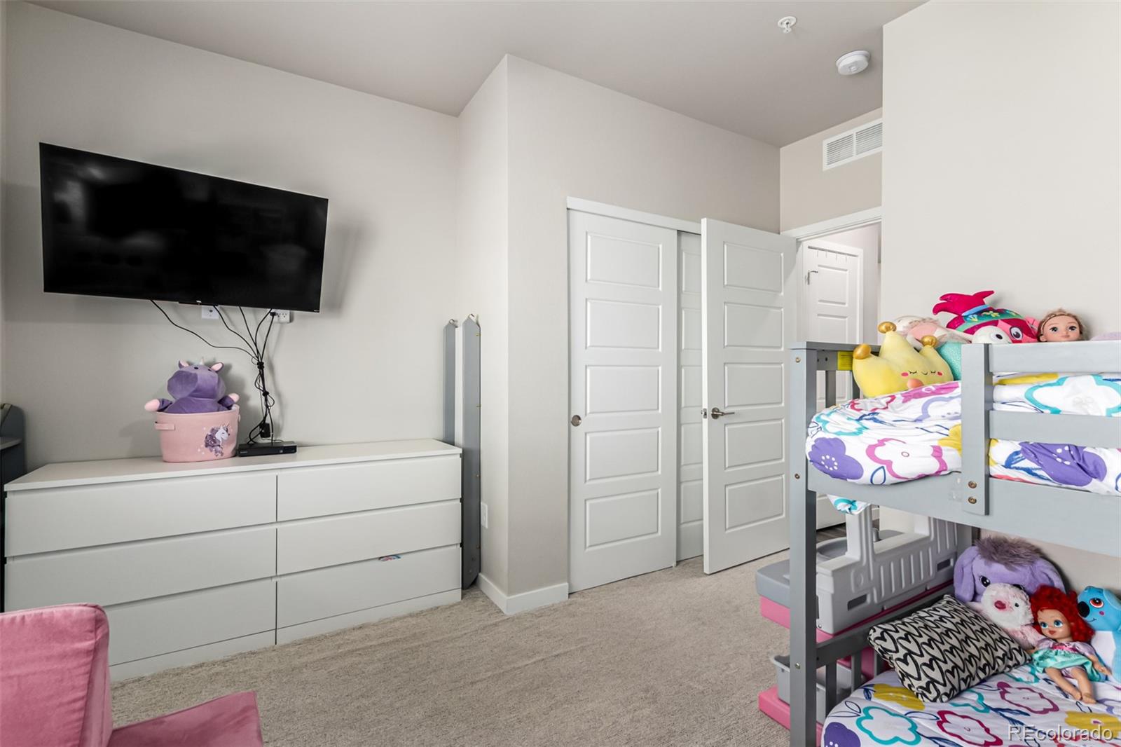 9287 Twenty Mile Road, Unit 204 Parker, CO 80134 - Photo 19 of 30 a bedroom with a bed and a small space