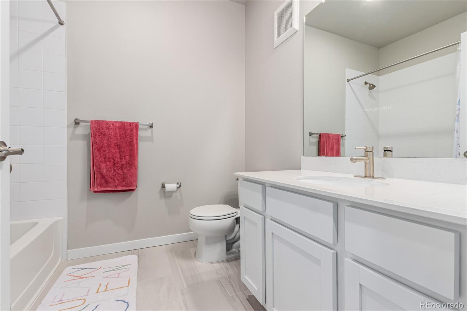 9287 Twenty Mile Road, Unit 204 Parker, CO 80134 - Photo 20 of 30 a bathroom with a toilet sink vanity and tub