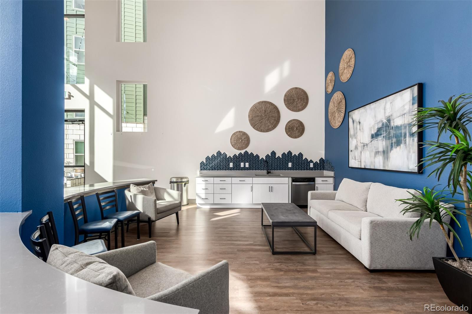 9287 Twenty Mile Road, Unit 204 Parker, CO 80134 - Photo 26 of 30 a living room with couches and a large window with garden view