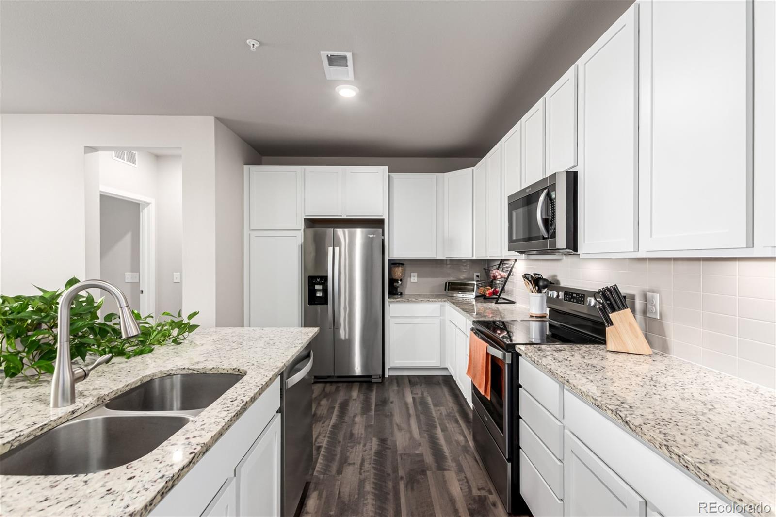 9287 Twenty Mile Road, Unit 204 Parker, CO 80134 - Photo 8 of 30 a kitchen with a sink stove and refrigerator