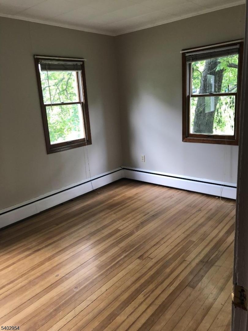 157 Highway 31 Washington, NJ 07882 - Photo 13 of 14 a view of an empty room with wooden floor and a window