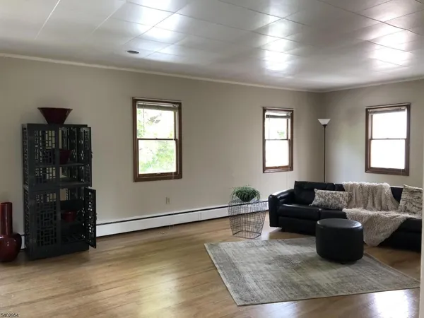 a living room with furniture window and wooden floor