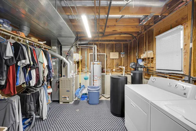 a living room with furniture a fireplace and a large window