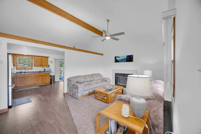 a view of a deck that has table and chairs with wooden floor and fence