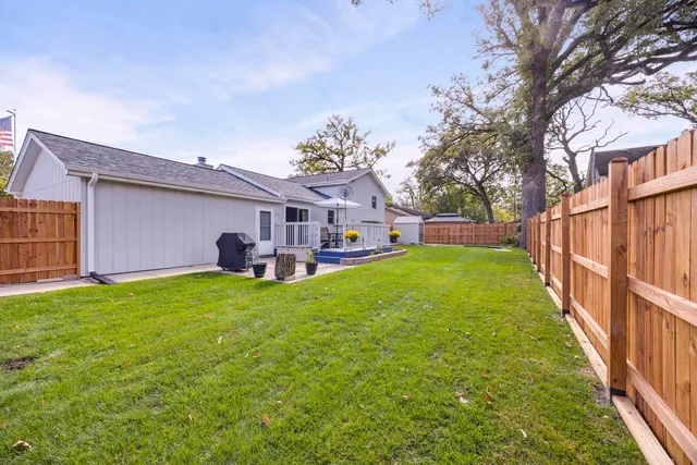 a view of a house with a backyard and a patio
