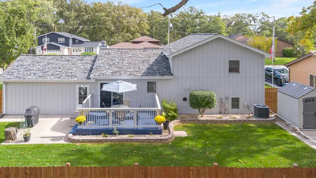 a view of a house with a yard patio and fire pit