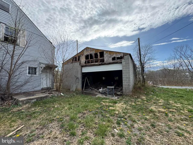 a view of a house next to a yard with road