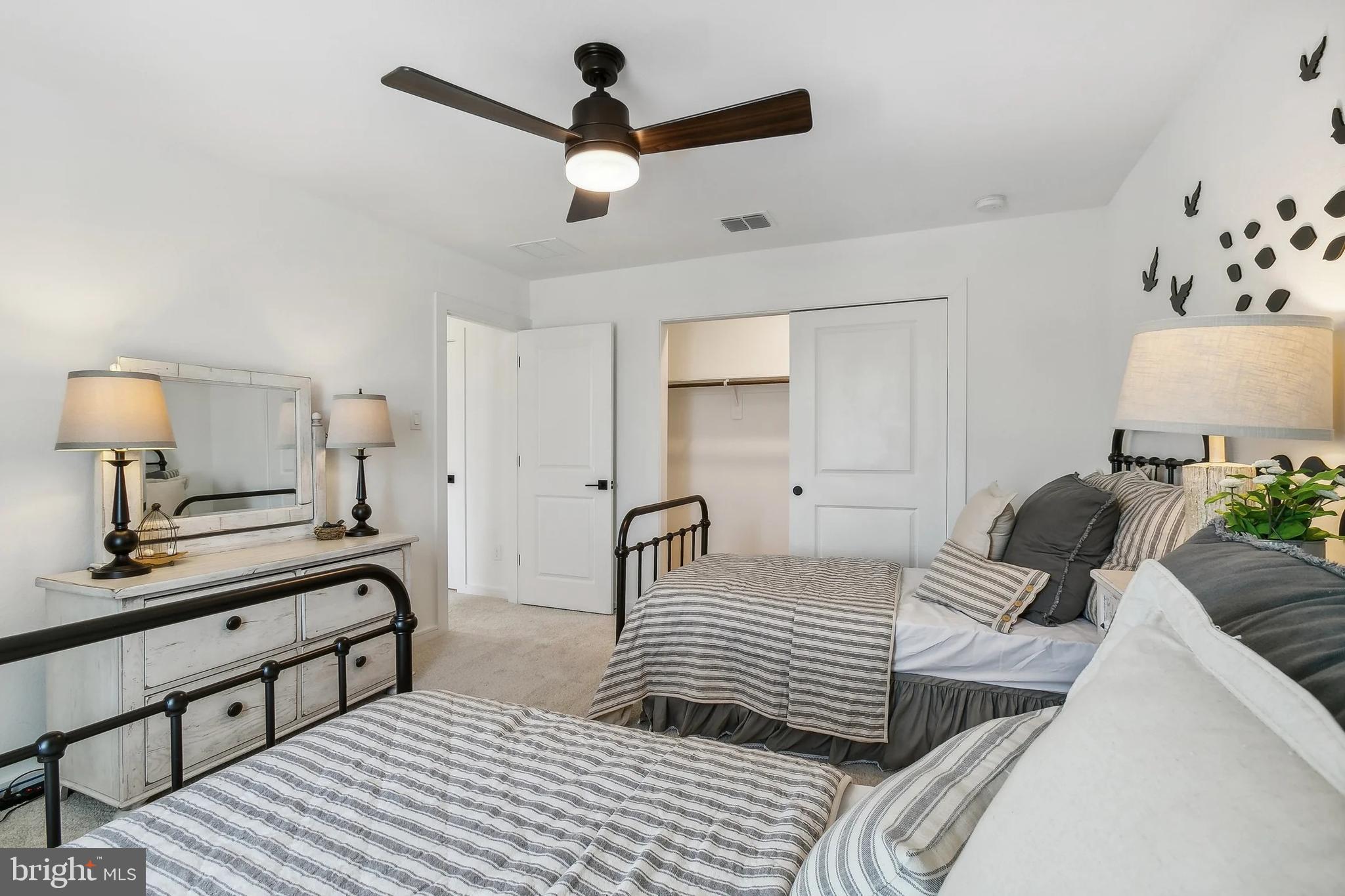 (lot 417-tbd Lot 417-tbd Ranson, WV 25438 - Photo 23 of 26 a bedroom with a bed and a chandelier