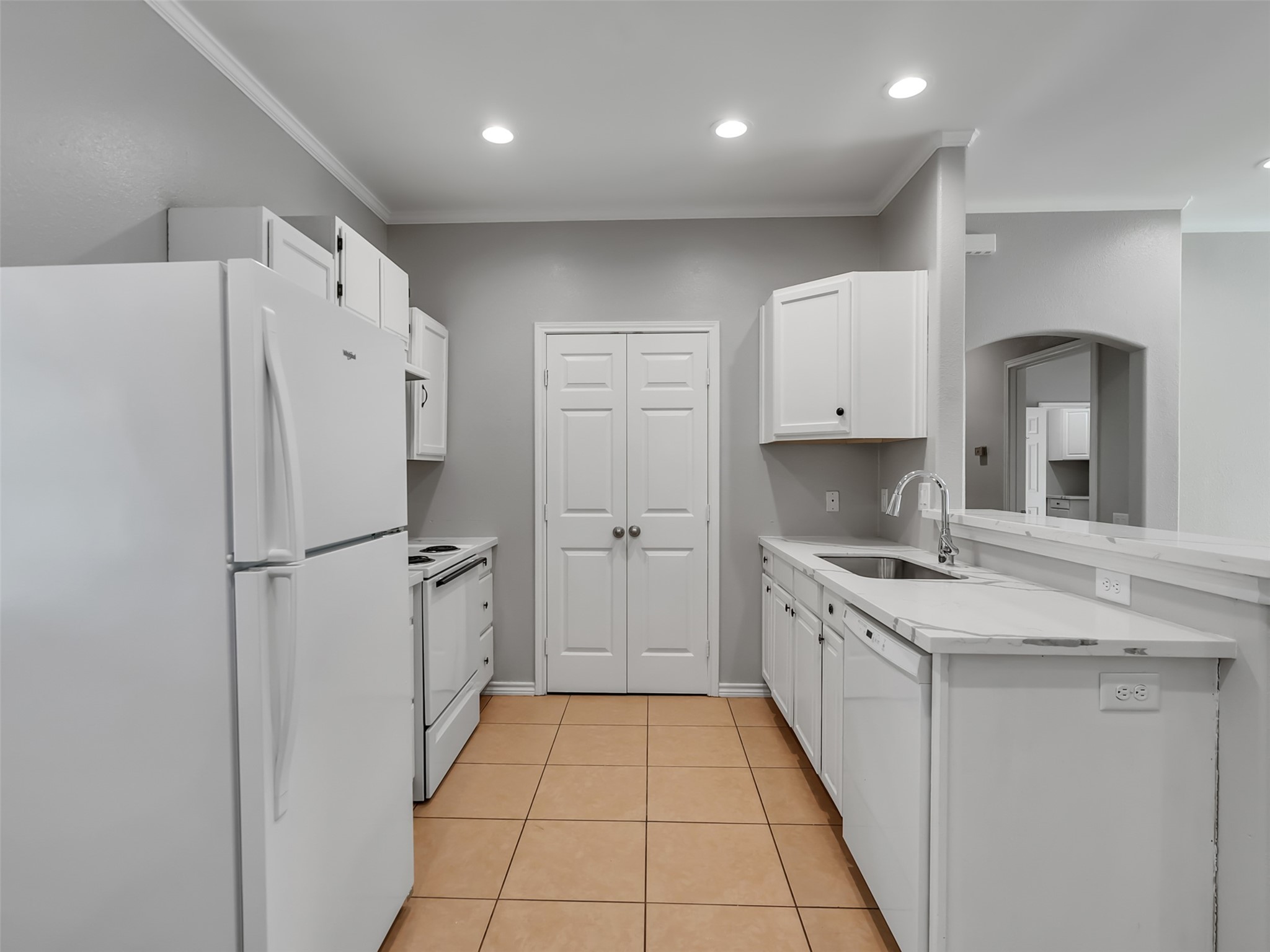 104 Longstreet Road, Unit 2 Willis, TX 77378 - Photo 12 of 26 a kitchen with white cabinets and white appliances