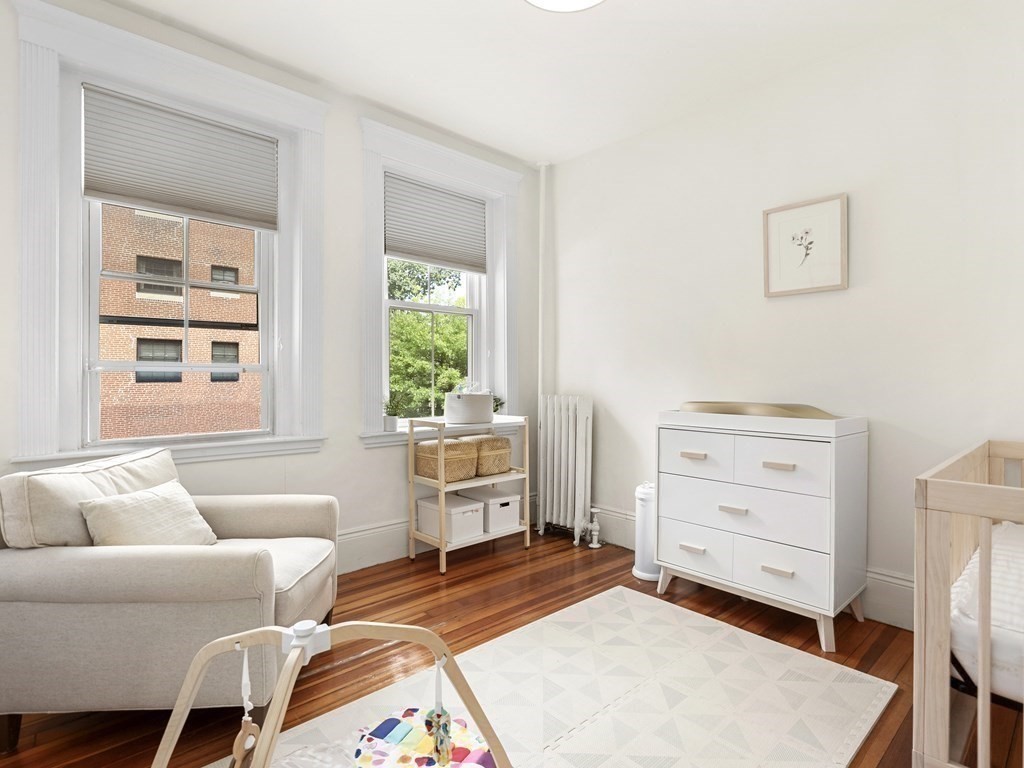 640 Washington Street, Unit 1 Brookline, MA 02446 - Photo 12 of 18 a bedroom with furniture and a window