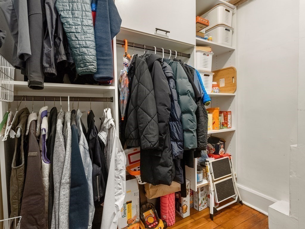 640 Washington Street, Unit 1 Brookline, MA 02446 - Photo 15 of 18 a view of walk in closet with clothes and shoes