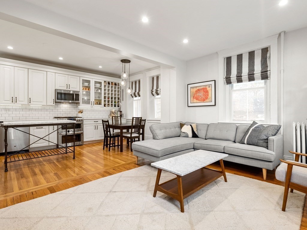 640 Washington Street, Unit 1 Brookline, MA 02446 - Photo 2 of 18 a living room with furniture and kitchen view