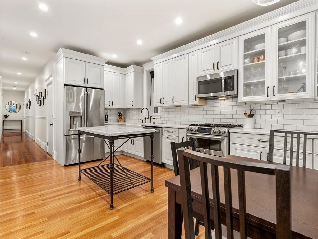 640 Washington Street, Unit 1 Brookline, MA 02446 - Photo 3 of 18 a kitchen with stainless steel appliances granite countertop a stove a sink a microwave a refrigerator and cabinets