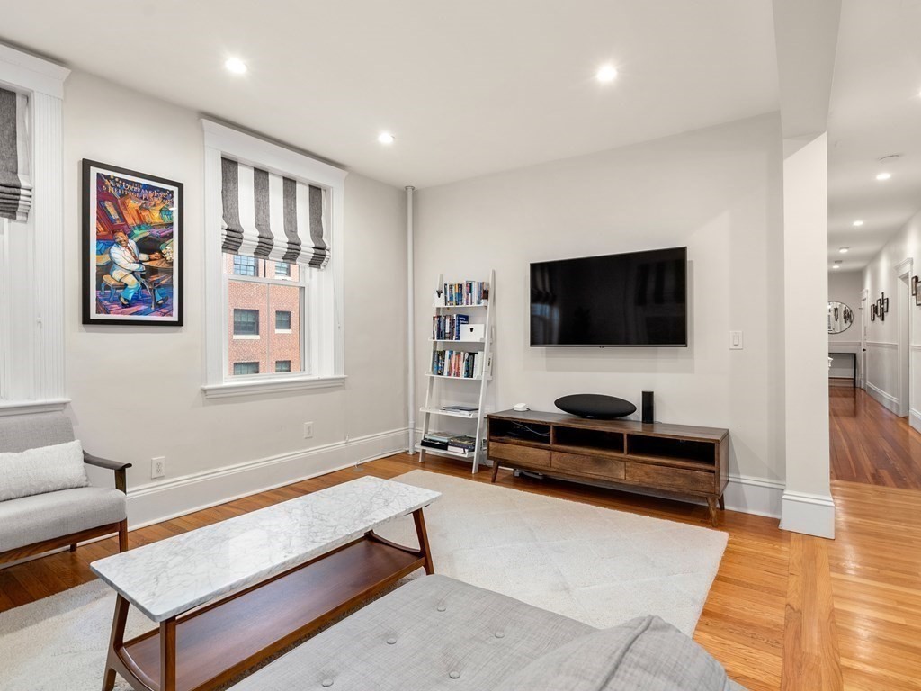 640 Washington Street, Unit 1 Brookline, MA 02446 - Photo 7 of 18 a living room with furniture and a flat screen tv