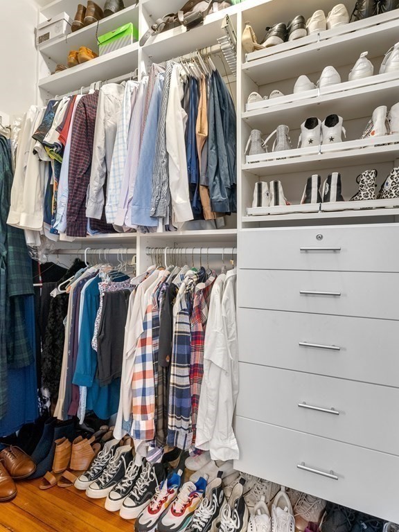640 Washington Street, Unit 1 Brookline, MA 02446 - Photo 10 of 18 a view of walk in closet with clothes and shoes