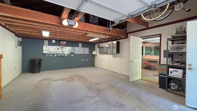 a view of an empty room with wooden floor and windows