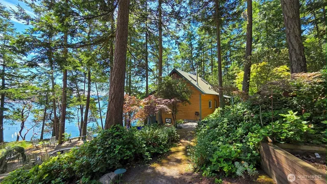 an aerial view of a house with swimming pool and garden