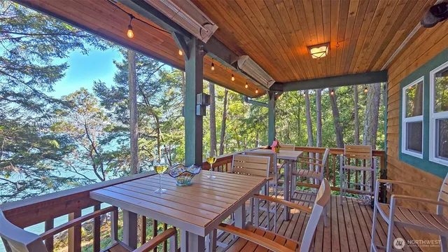 a view of a patio with a table chairs and a backyard