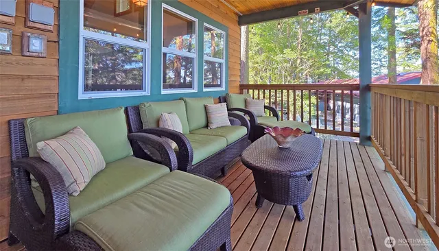 a balcony with two chairs and a wooden floor