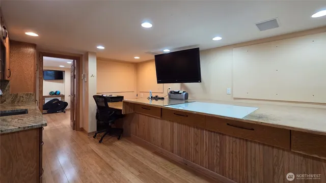 a kitchen with stainless steel appliances granite countertop a sink stove and cabinets