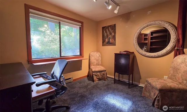 a room with chair and two windows