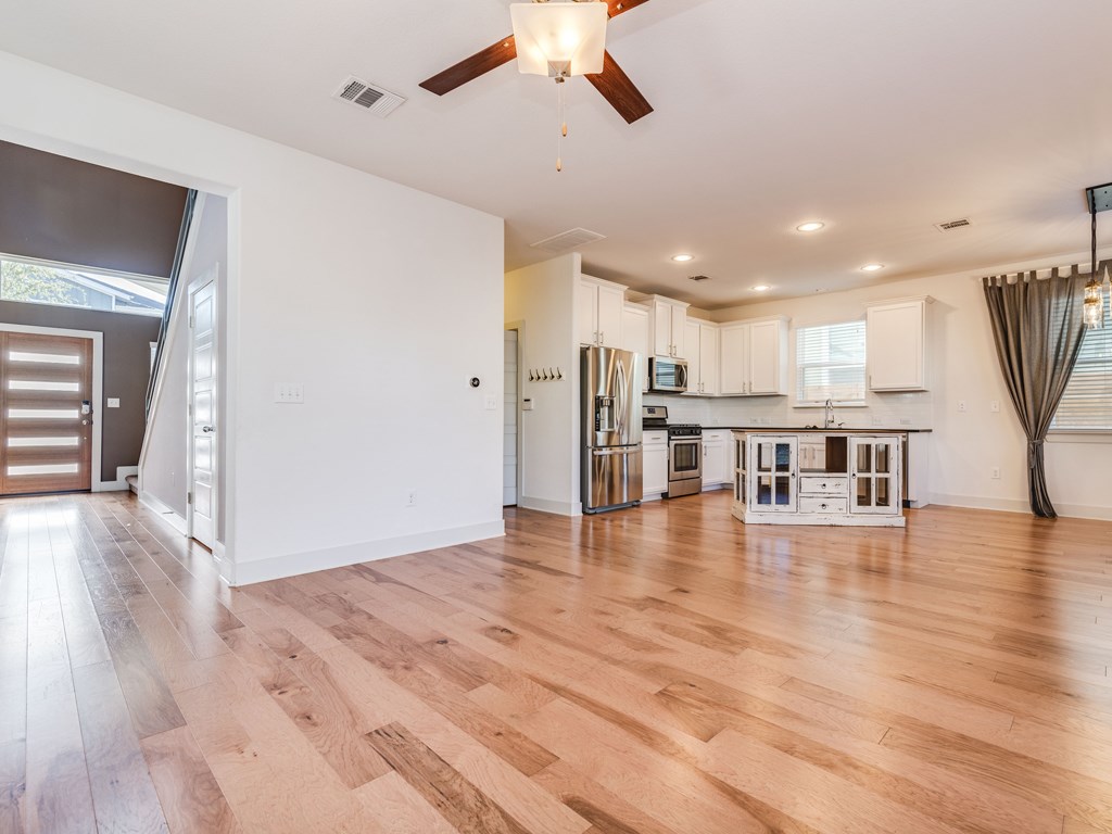 2208 Capulet Street Austin, TX 78741 - Photo 4 of 23 a view of a kitchen with a white kitchen and a chandelier