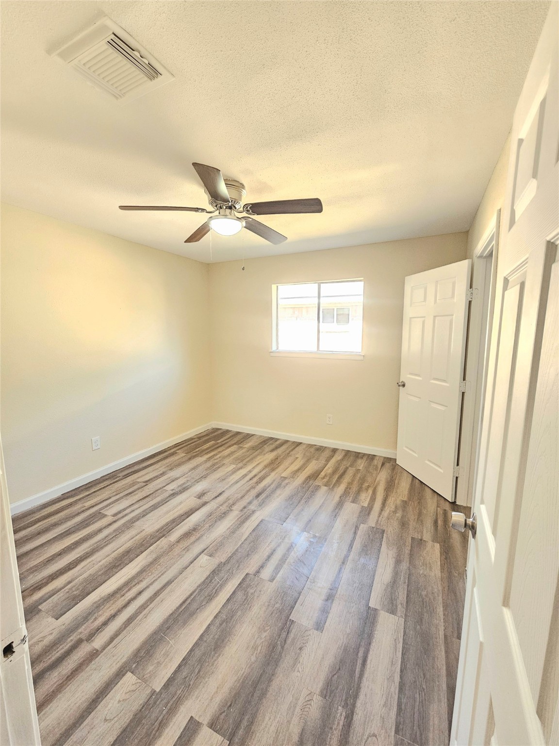 5026 Fitzwater Drive Spring, TX 77373 - Photo 14 of 18 wooden floor in an empty room with a window