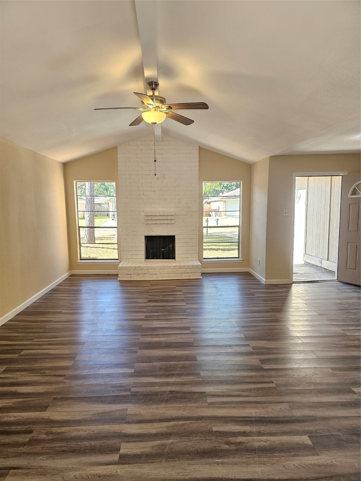 5026 Fitzwater Drive Spring, TX 77373 - Photo 4 of 18 an empty room with wooden floor chandelier fan and windows