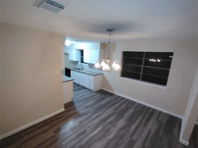 a living room with hard wood floors and a fireplace