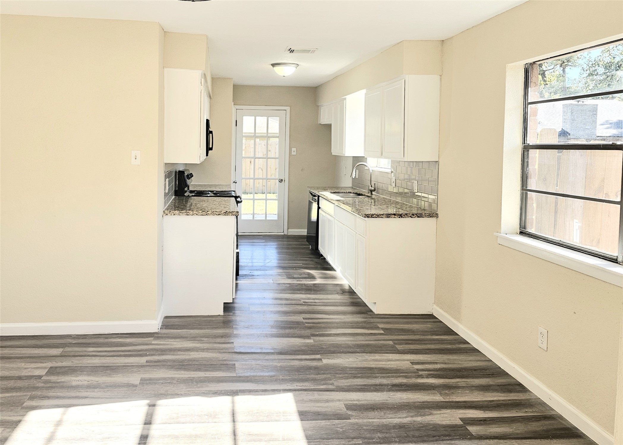 5026 Fitzwater Drive Spring, TX 77373 - Photo 8 of 18 a kitchen with a refrigerator and white cabinets