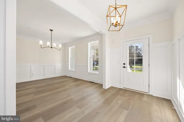 a kitchen with white cabinets stainless steel appliances and a fireplace