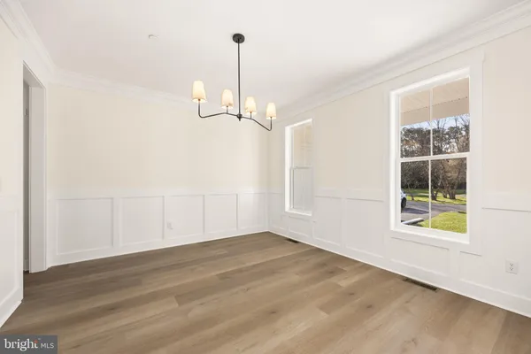 a kitchen with stainless steel appliances granite countertop a stove a sink and white cabinets