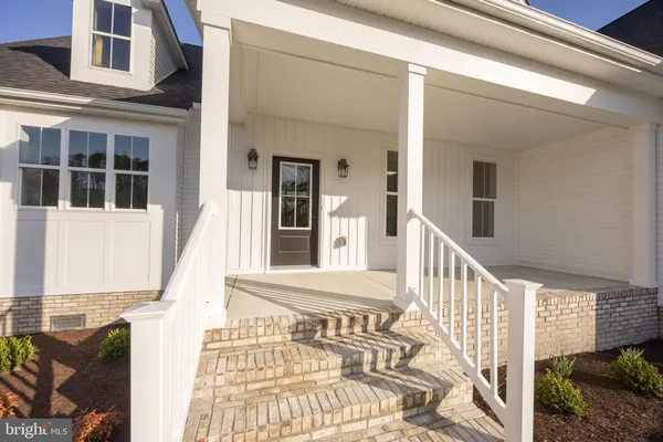 a view of a hallway with wooden floor and entryway