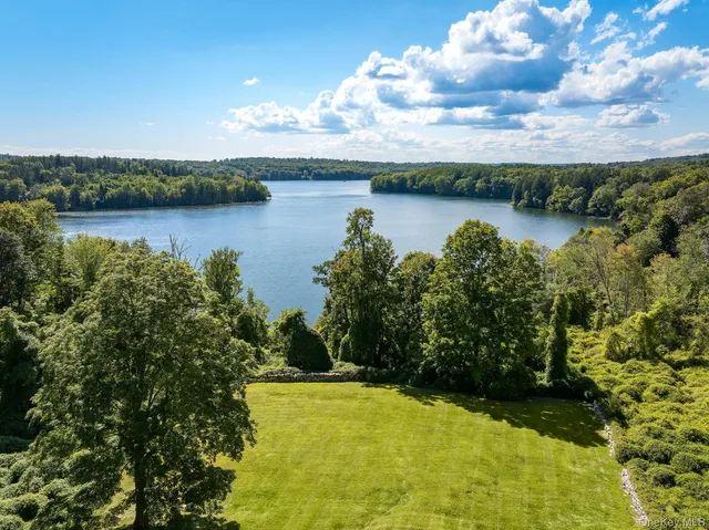 a view of house with swimming pool outdoor seating